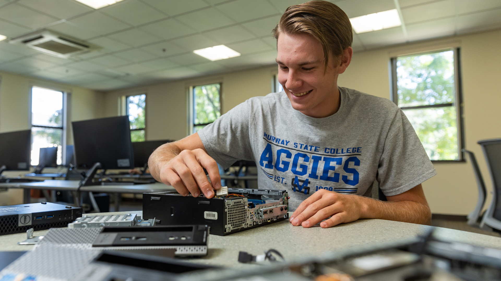 Student repairing a desktop computer